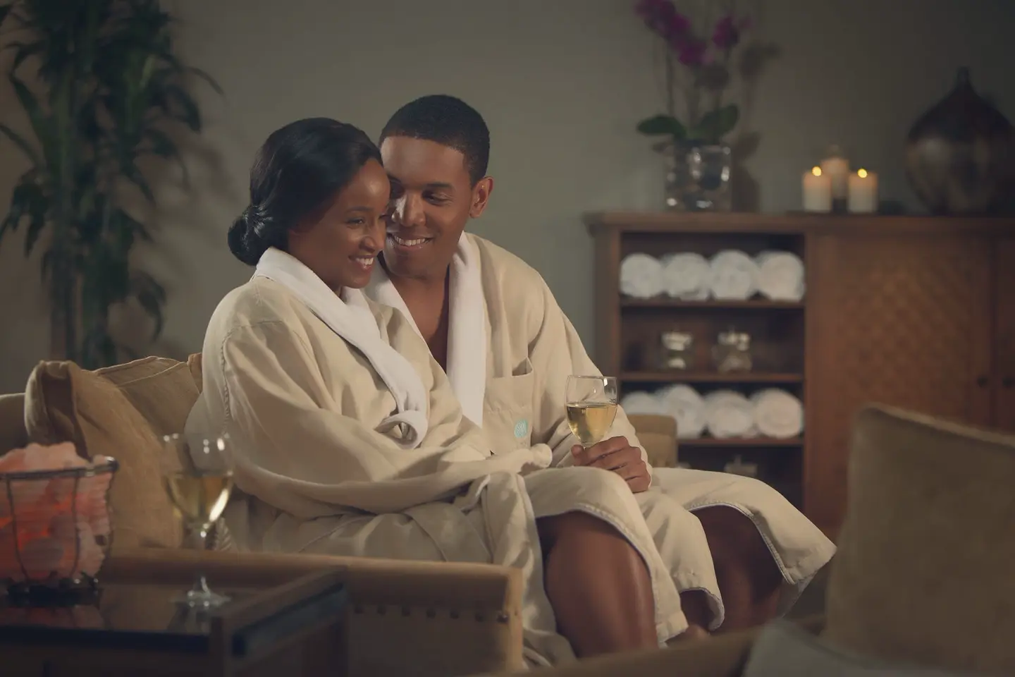 Two guests in Relâche Spa robes relax together in the spa lounge